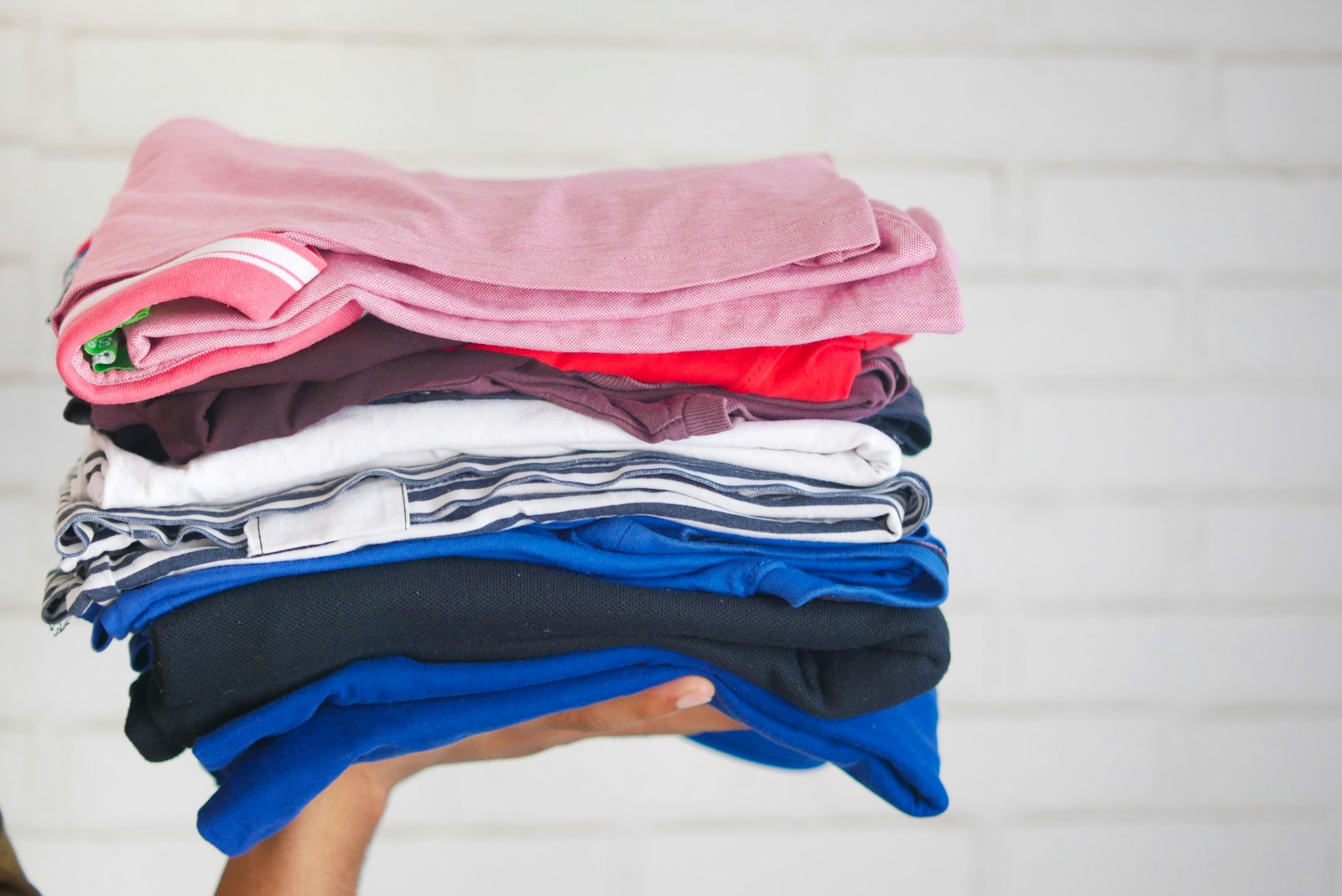 Stack of freshly washed and folded laundry - Dora Ironing Service